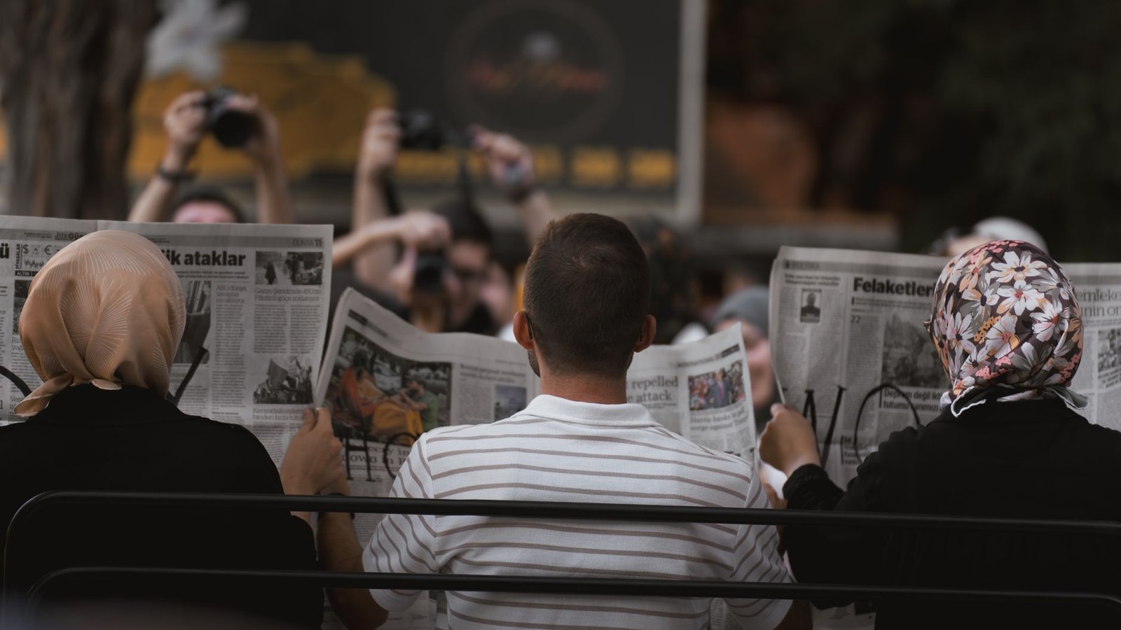 A candid moment of people reading newspapers on a bench in Ankara park. — Crypto casino no wager bonus